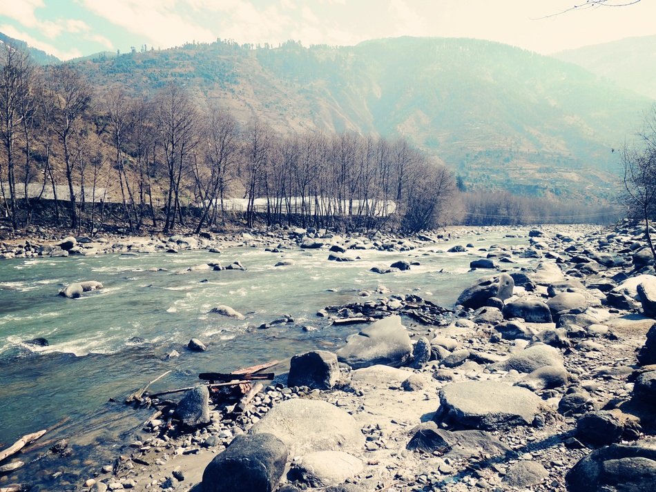 river with stones near the hill