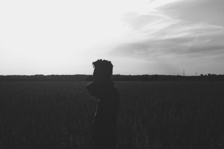 silhouette of a man in a field