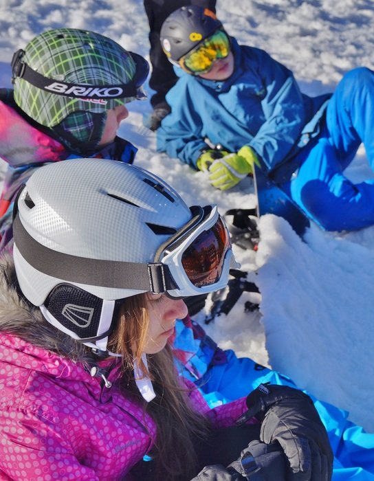 skiers in helmets on the mountain