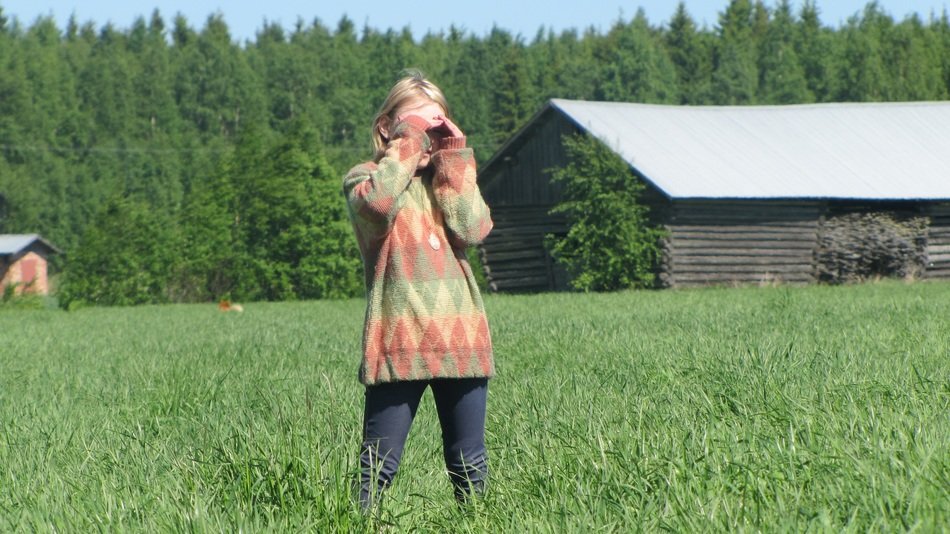 girl standing in the grass on the field