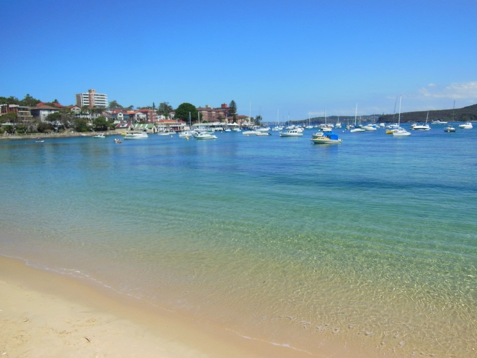 boats in ocean bay with clear water