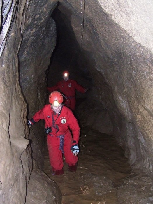 man in a red suit in a cave