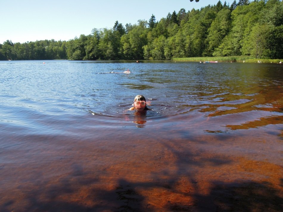 man swimming in the lake