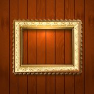 Vintage gold frame on a wooden texture