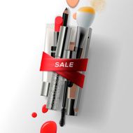 Various makeup brushes and cosmetics with red ribbon Sale poster