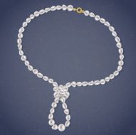 Freshwater Pearls Necklace with a loop on dark background