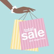 Woman&#039;s hand holding shopping bags