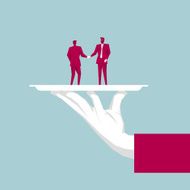 Hand holding tray Two businessmen shaking hands in the tray