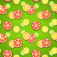 Slices of fresh citrus fruits on green polka dot background