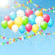 Balloons and pennants on sky background