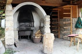 wood in front of stone charcoal oven