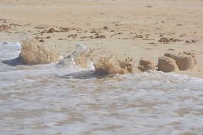 waves blur sand castle