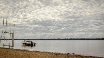 boat of fishermen on the river near the shore