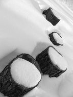 lmonochrome photo of logs from a tree in the snow