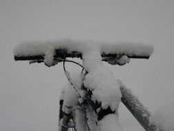 snow-covered steering wheel bicycle