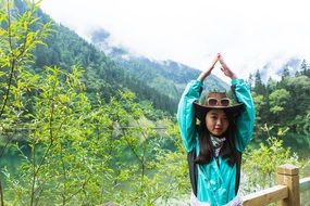 Photo of a cute girl on a background of a mountain