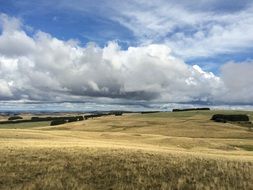 Scenic fields on a background cloudy sky in France