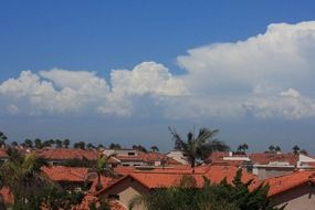 cumulus clouds over a village in california