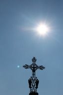 openwork cross on a building against the blue sky