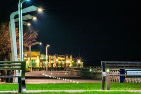luminous street lamps along the waterfront in the evening