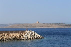 Stones in the beautiful lagoon with blue water in Malta