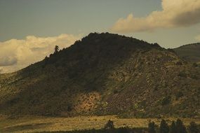 green hills in the shadow of the clouds