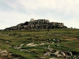 rocky green hill in spain