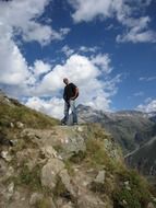 man top of mountain alps