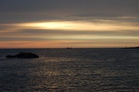 sunrise behind the clouds over the ocean