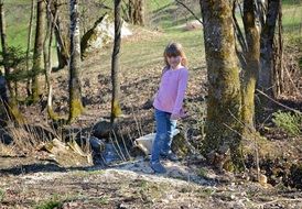 human child girl blond in the spring forest