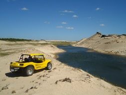 yellow bug car on sand beach