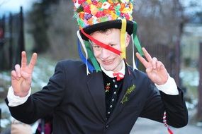 young boy in colorful carnival hat having fun