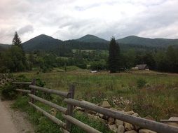 wooden fence in a field among the picturesque Carpathians