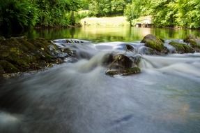 Beautiful river as a water element with colorful plants