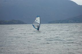 windsurfing on lake como on a cloudy day