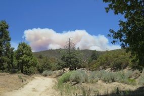 puffs of white smoke over picturesque landscape