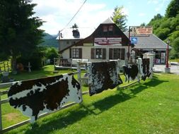 mountain chalet with cow skins drying on a sunny day