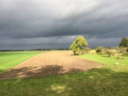 gray storm clouds over the arable field