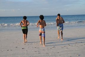 three guys on the sandy beach