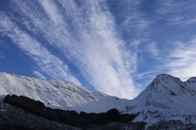 snowy mountains and winter blue sky scene