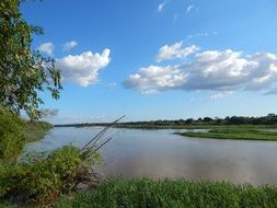 beautiful landscape with wide river, green riverside and blue sky, brazil, piauí