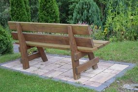 Wooden bench in the green garden
