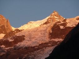 landscape of brown alpine mountains at the sunset