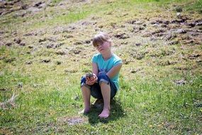 Child sitting on a meadow