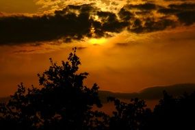 golden sky over the hills in summer