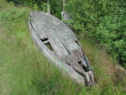 old wooden boat on green grass