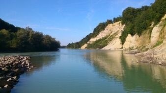 Beautiful panorama of a quiet river among the hills with plants