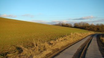 asphalt road in a green meadow