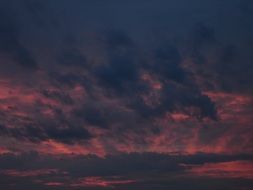 black clouds on the pink sky