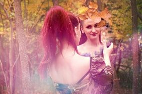 mystical picture of girl looks in the mirror in the forest